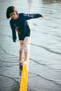 Full length of woman standing in lake