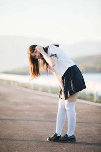 Portrait of woman standing on road