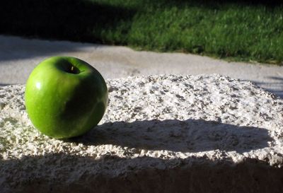 Green apple on wall