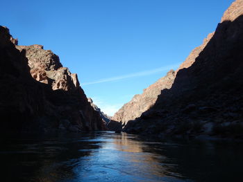 Scenic view of mountains against clear blue sky