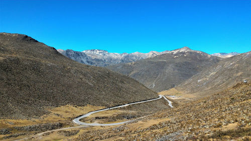 High angle view of mountain road against clear blue sky