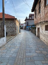 Empty alley amidst buildings in city