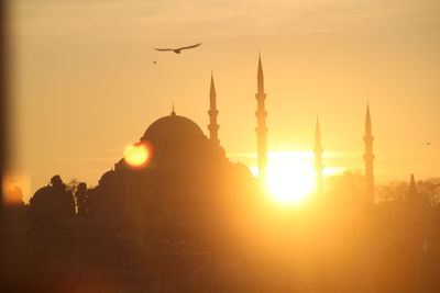 Silhouette of building against sky during sunset