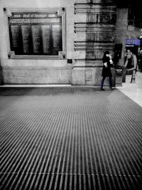 People walking on railroad station