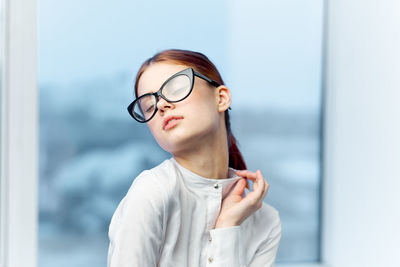 Close-up of businesswoman with closed eyes