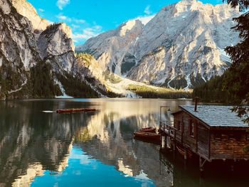 Scenic view of lake by mountains against sky