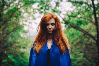 Portrait of beautiful woman standing in forest