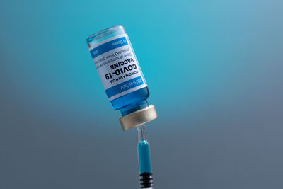 Close-up of bottle against blue background