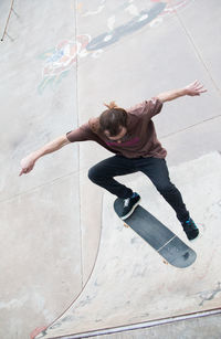 Skateboarder jumping in ramp