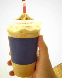 Close-up of hand holding coffee cup
