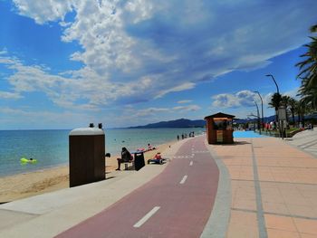 People on beach against sky