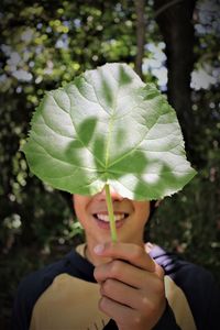 Close-up of woman holding leaves