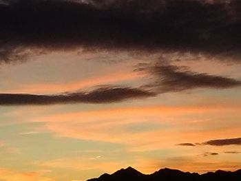 Scenic view of mountains against cloudy sky