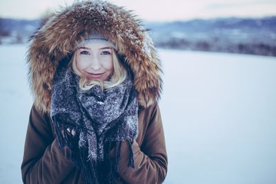 Portrait of smiling young woman in snow