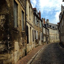 Street amidst buildings against sky