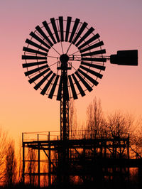 Silhouette ferris wheel against sky during sunset