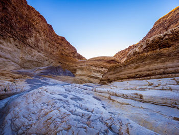 Scenic view of mountains against clear blue sky