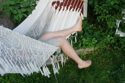 Low section of man sleeping in hammock