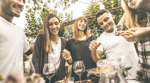 Friends eating food at vineyard