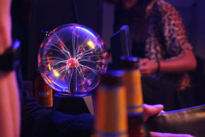 Close-up of hand holding illuminated lighting equipment