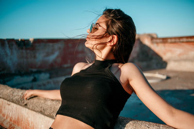 Midsection of woman standing against the sky