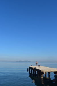 Scenic view of sea against clear blue sky