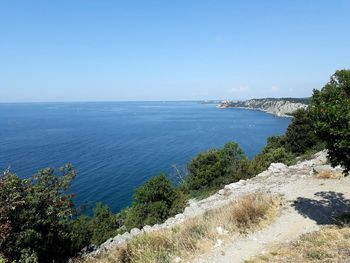 Scenic view of sea against clear blue sky