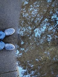 Low section of person standing on street