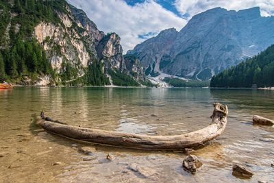 Scenic view of lake by mountains against sky