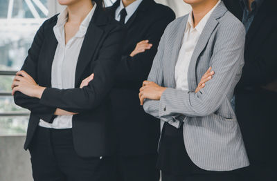 Midsection of woman standing with umbrella