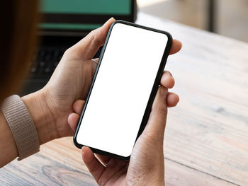 Close-up of hand holding mobile phone