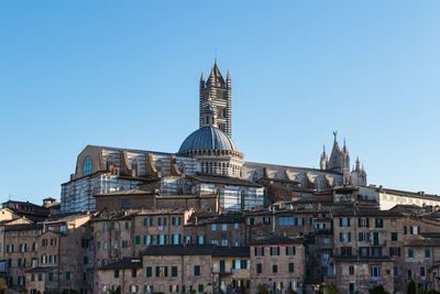 Low angle view of buildings against blue sky