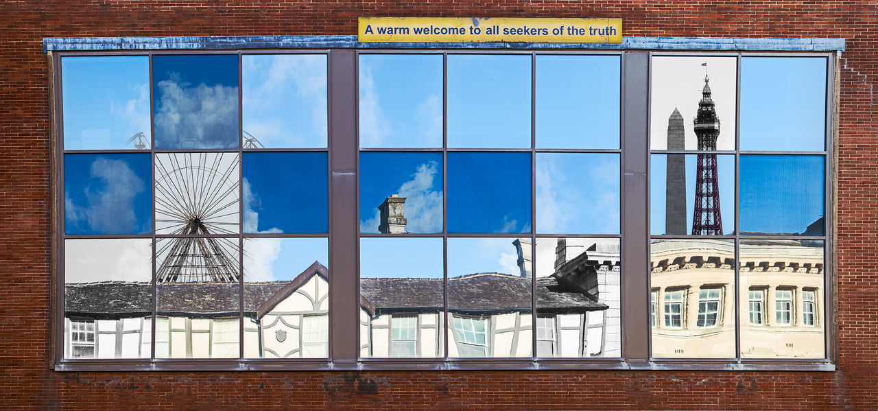 DIGITAL COMPOSITE IMAGE OF BUILDING WITH REFLECTION ON WINDOW