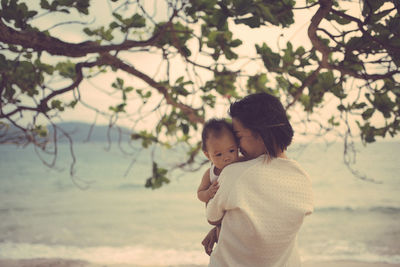 Woman with baby on the seaside