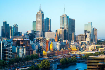 Modern buildings in city against clear sky