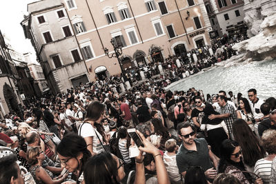 People on street amidst buildings in city