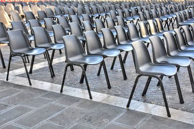 Empty chairs on footpath