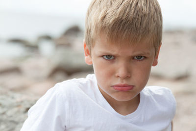 Close-up portrait of angry young boy