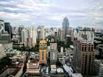 View of cityscape against cloudy sky