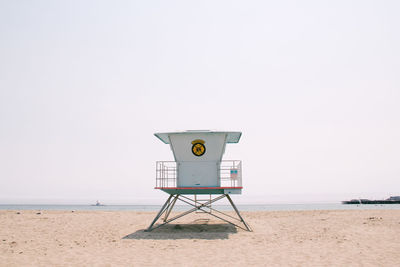 Lifeguard hut on beach against clear sky