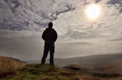 Rear view of man standing on landscape