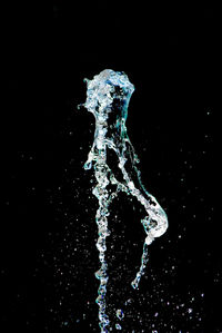 Close-up of water splashing against black background