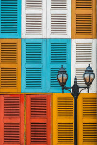 Low angle view of street light against colorful building