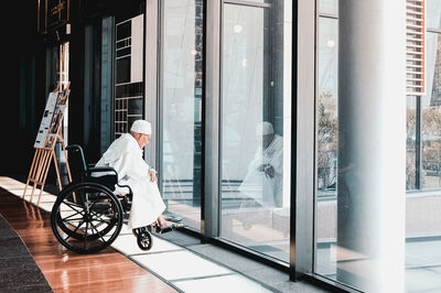 Man cycling on glass window