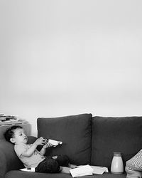 Young woman sitting on sofa at home