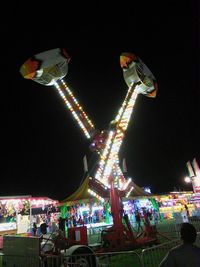 Low angle view of illuminated ferris wheel