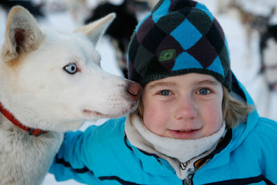 Close-up portrait of smiling boy with siberian husky