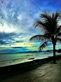 Scenic view of beach against cloudy sky