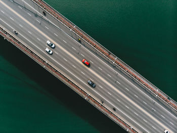 Aerial view of cars moving on bridge over sea