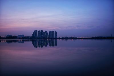 Scenic view of lake against sky at dawn